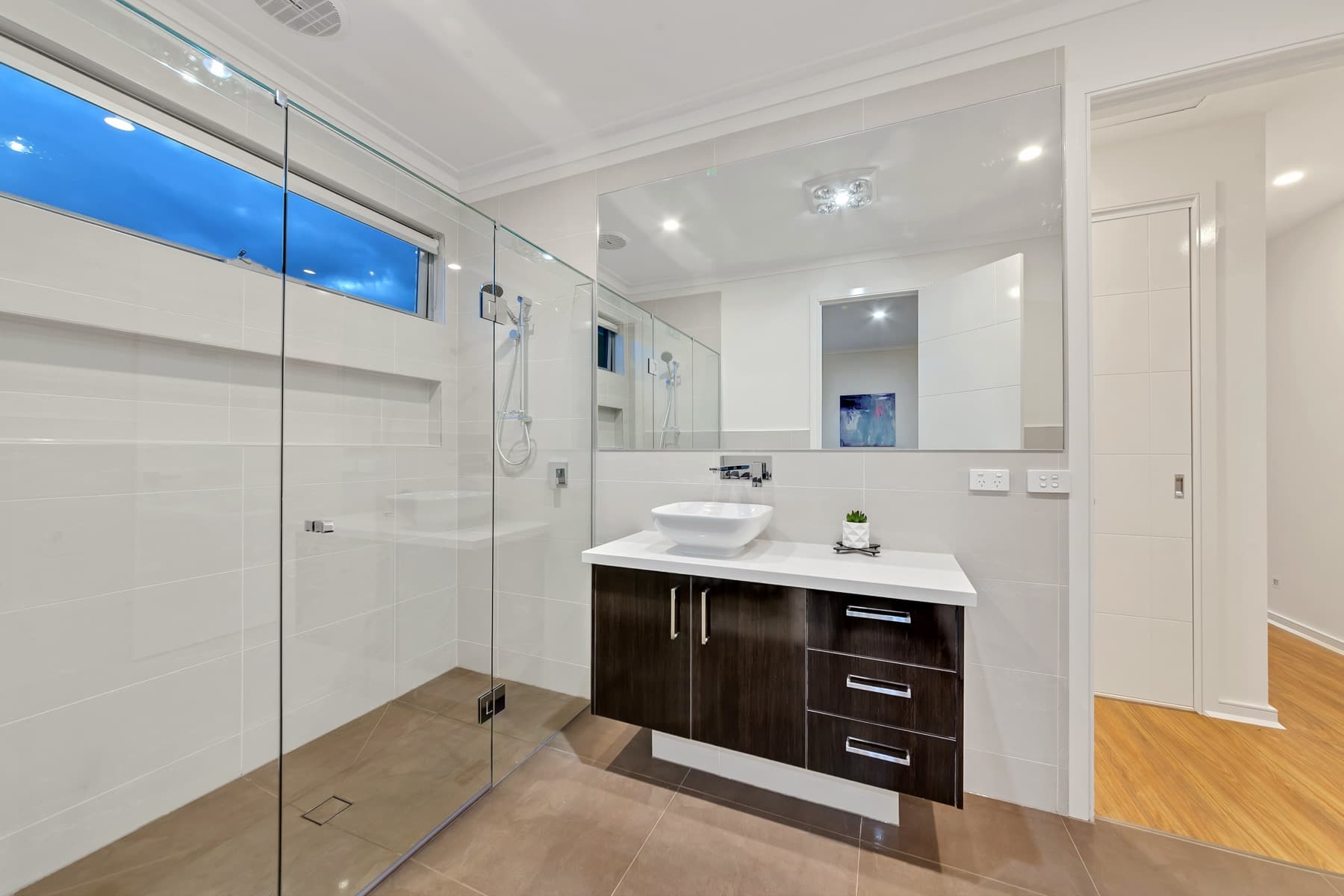 The shower behind its glass screen