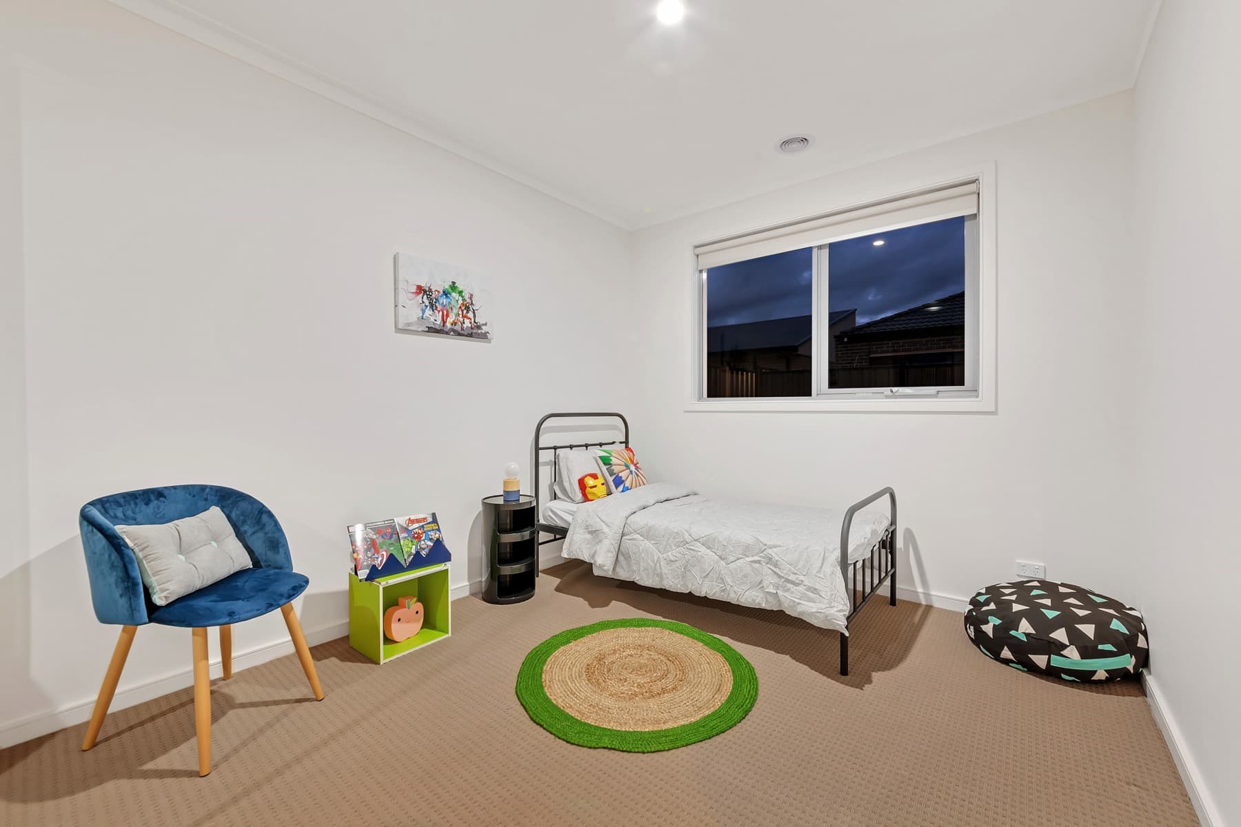 A child's bedroom, bed and toys by the window