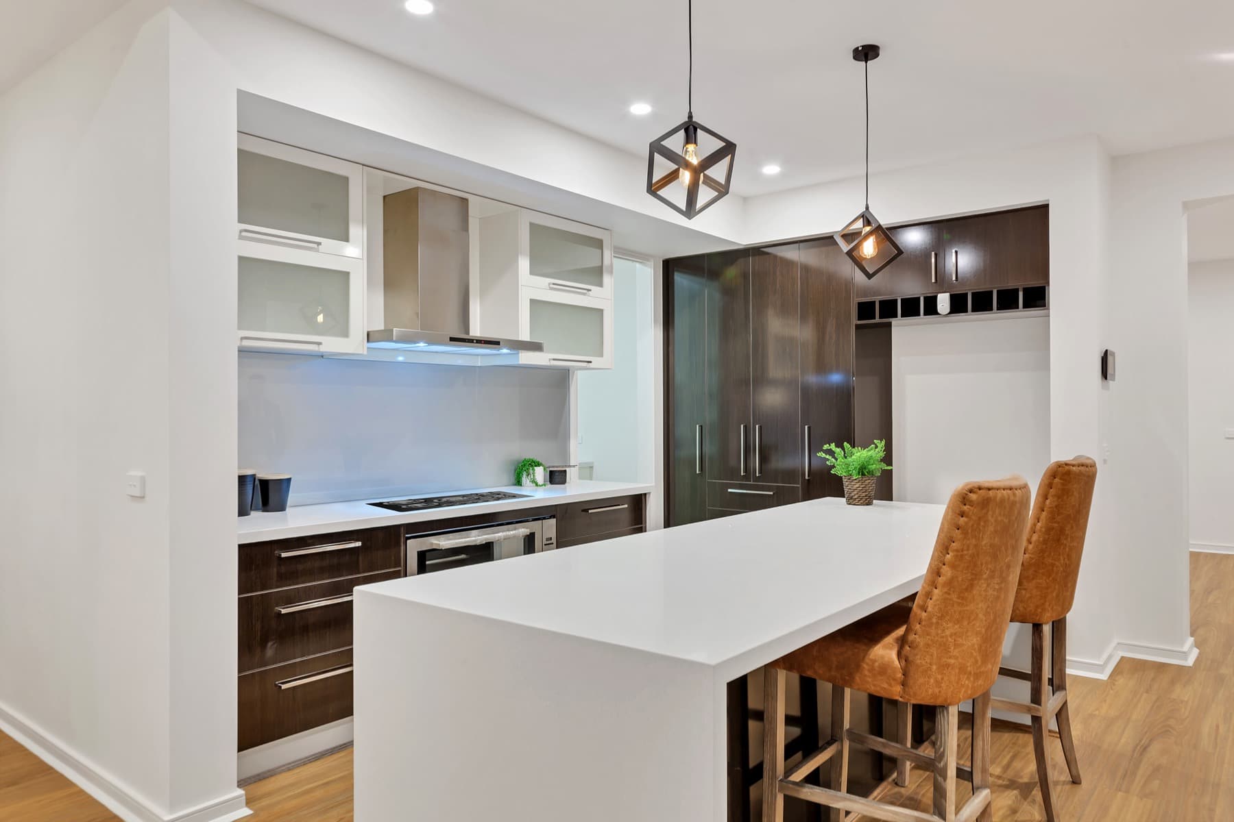 The kitchen island beneath twin pendants