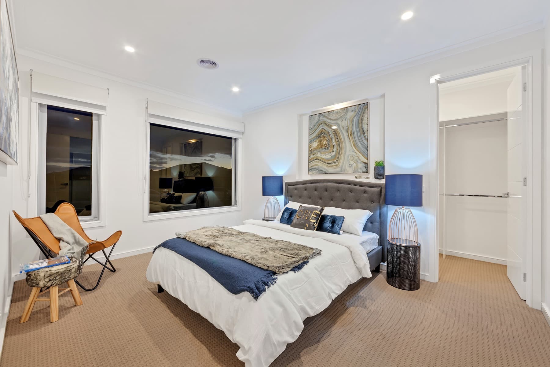 A bedroom with a staged bed