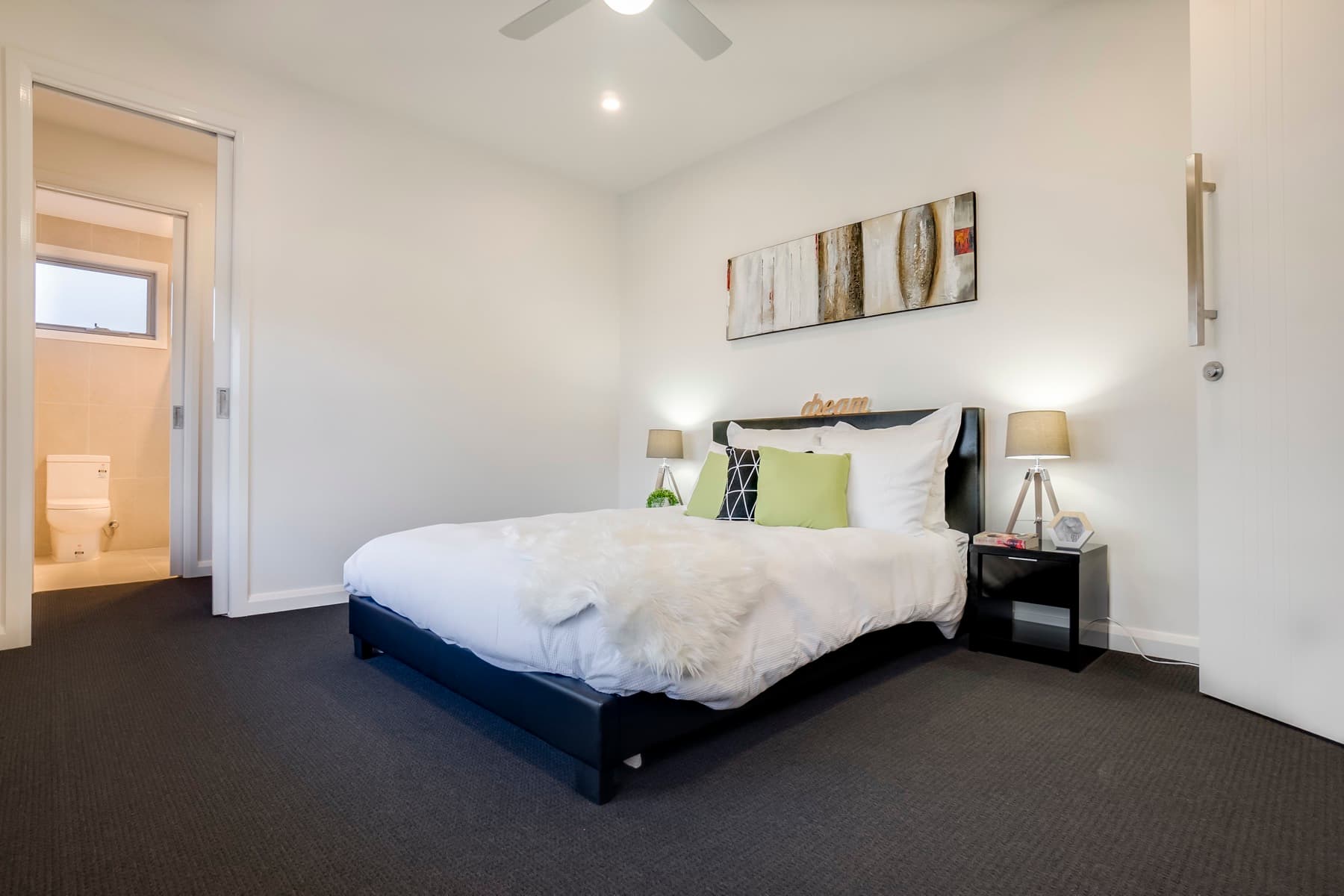 A bedroom with the ensuite beyond its door