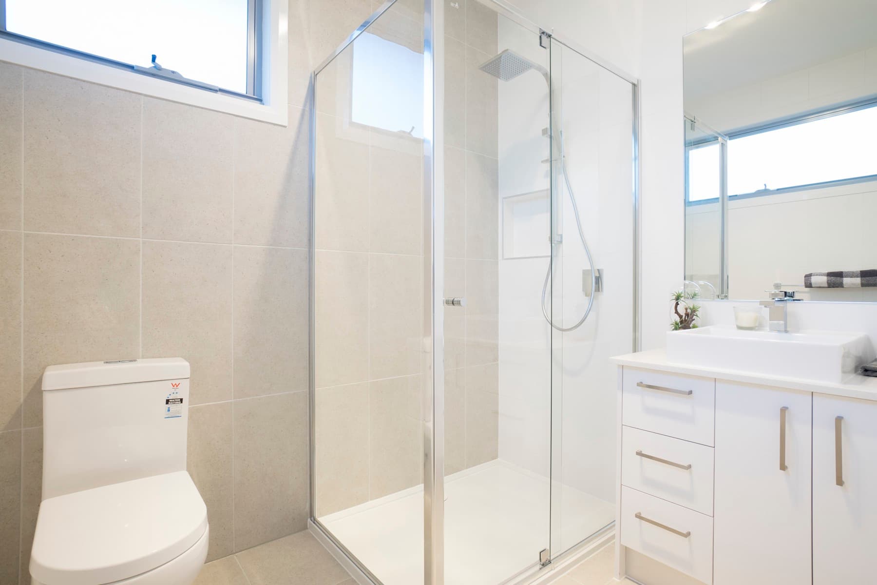 A bathroom with shower and vanity