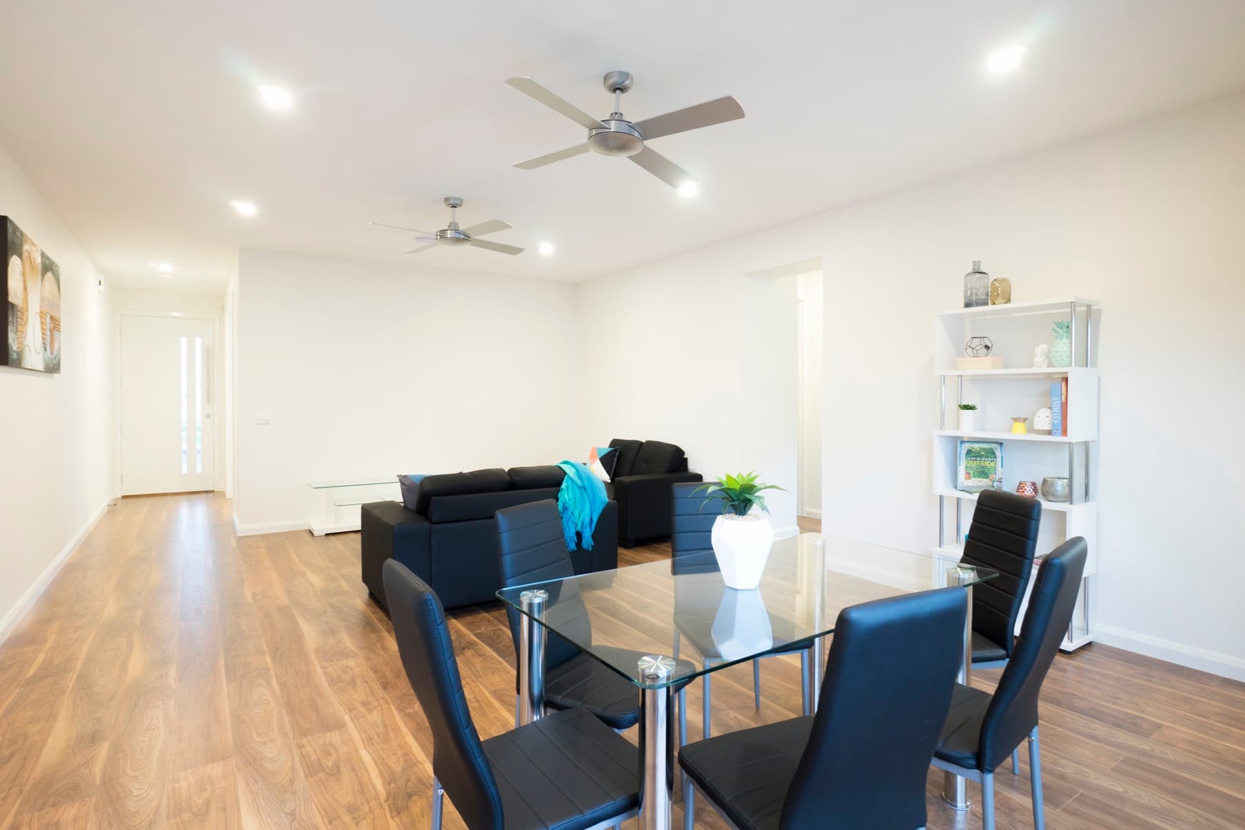 The living and dining space around a glass table