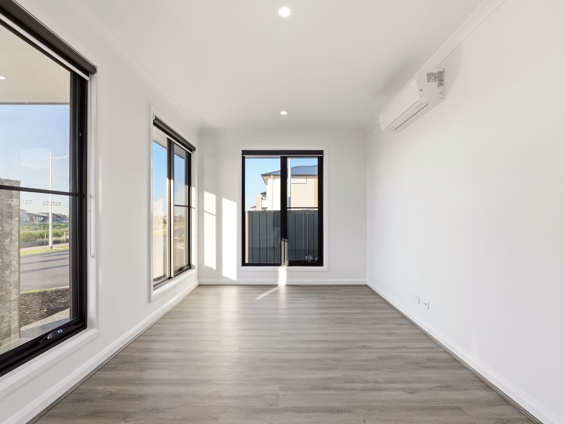 A front room at handover, morning light falling across the floor
