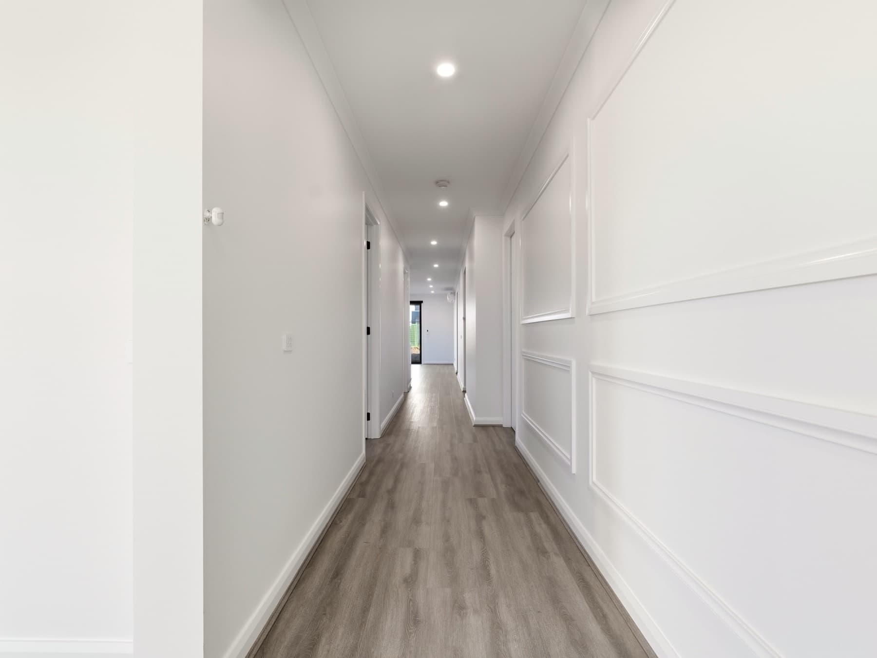 The panelled hallway running the spine of the home