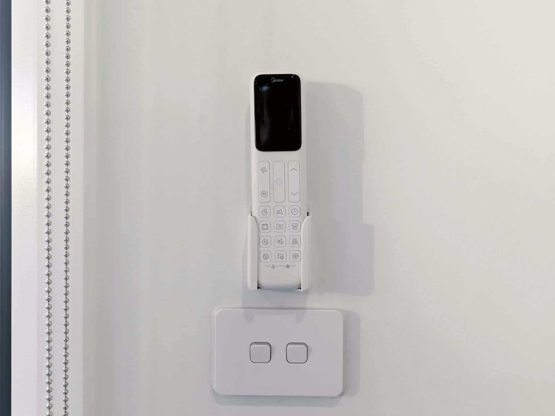 The climate control panel on a panelled wall