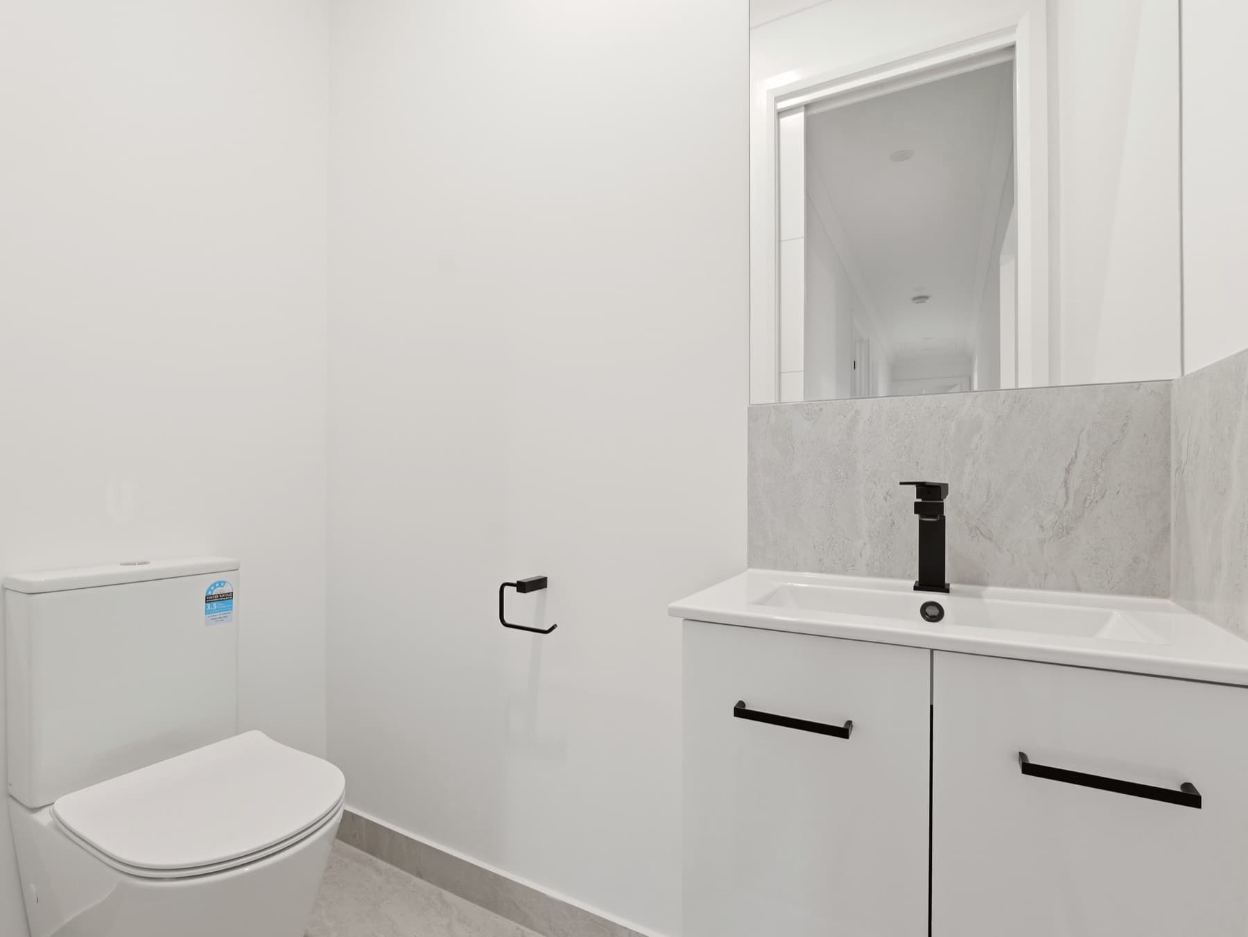 A powder room with black tapware