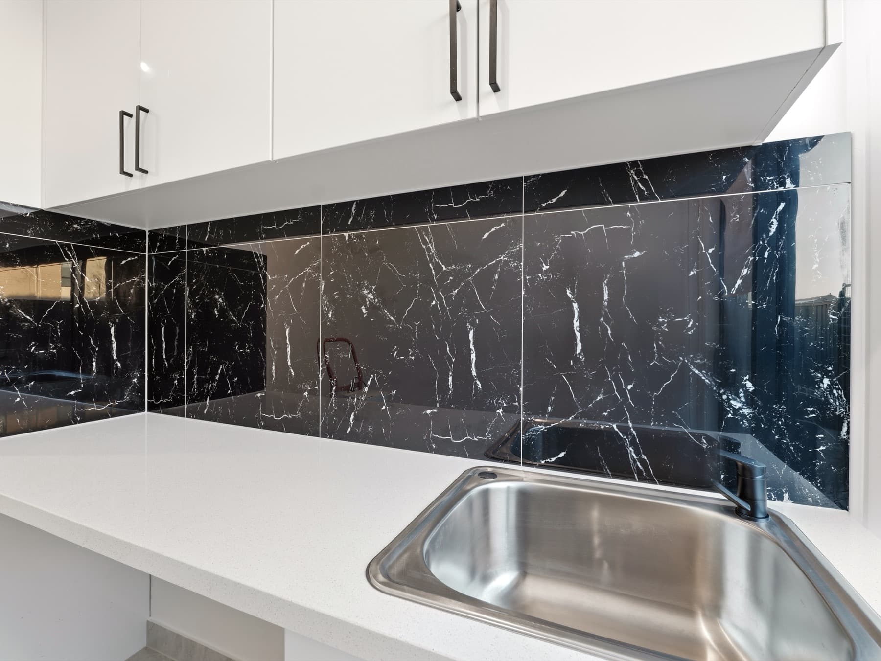 The laundry, stone splashback and steel sink