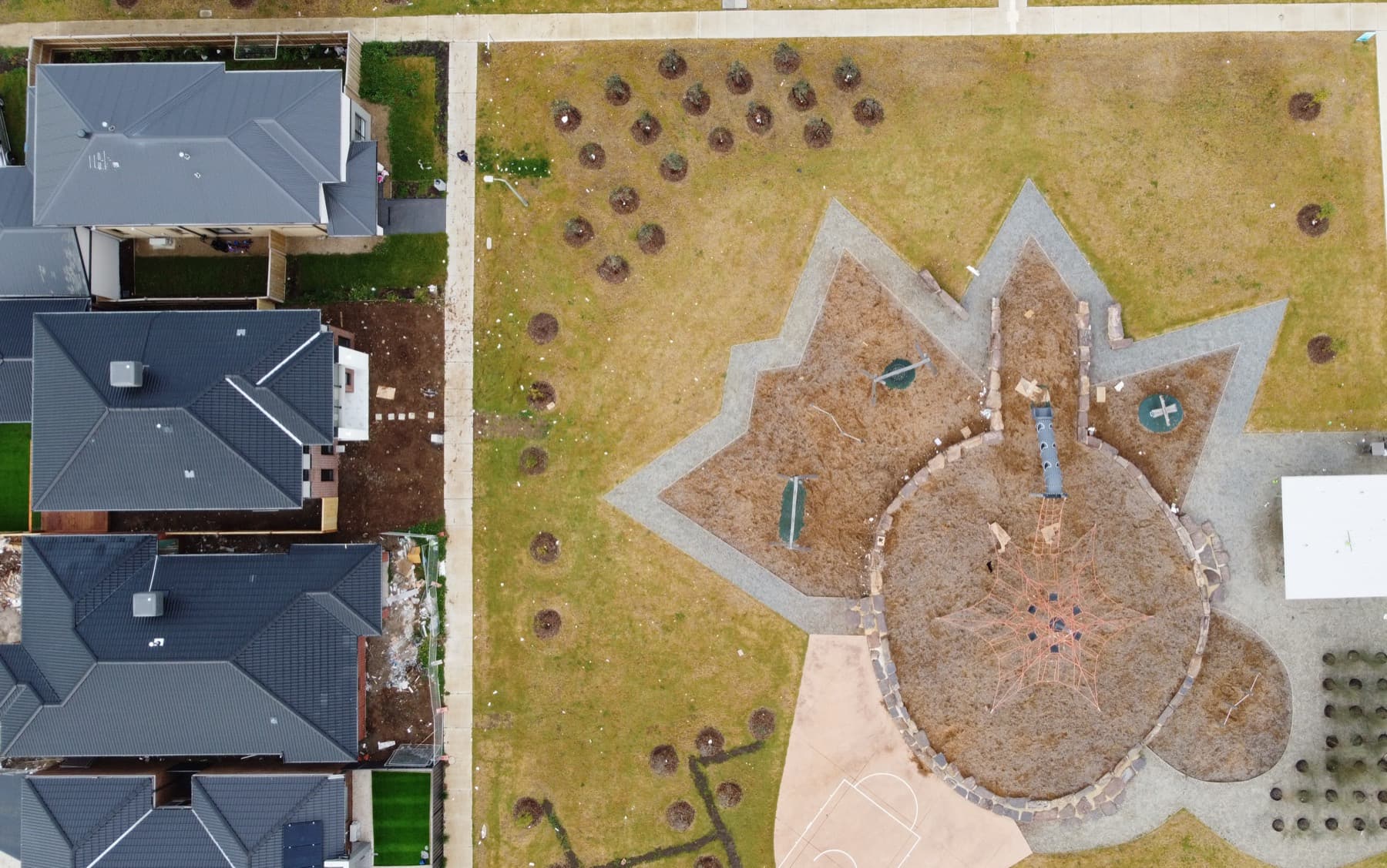 Looking straight down over the rooftop and the park beside the block