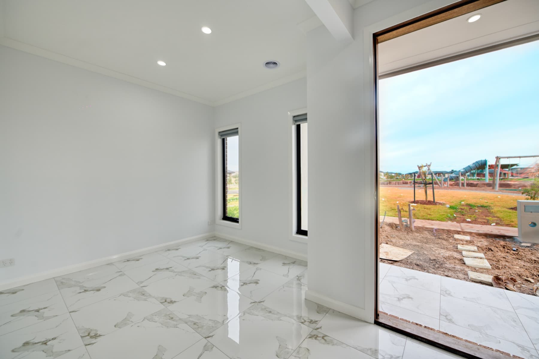 A room opening through sliding doors to the edge of the estate
