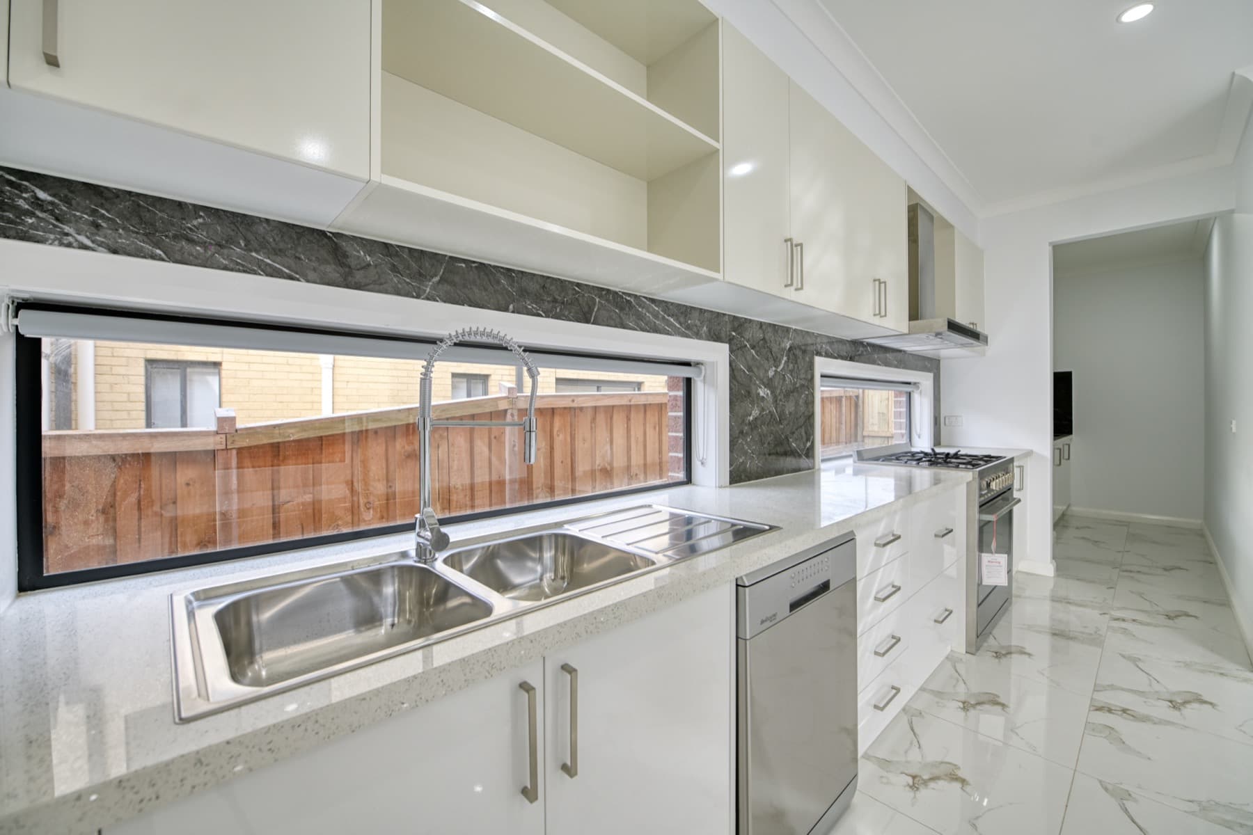 The kitchen sink beneath the window splashback