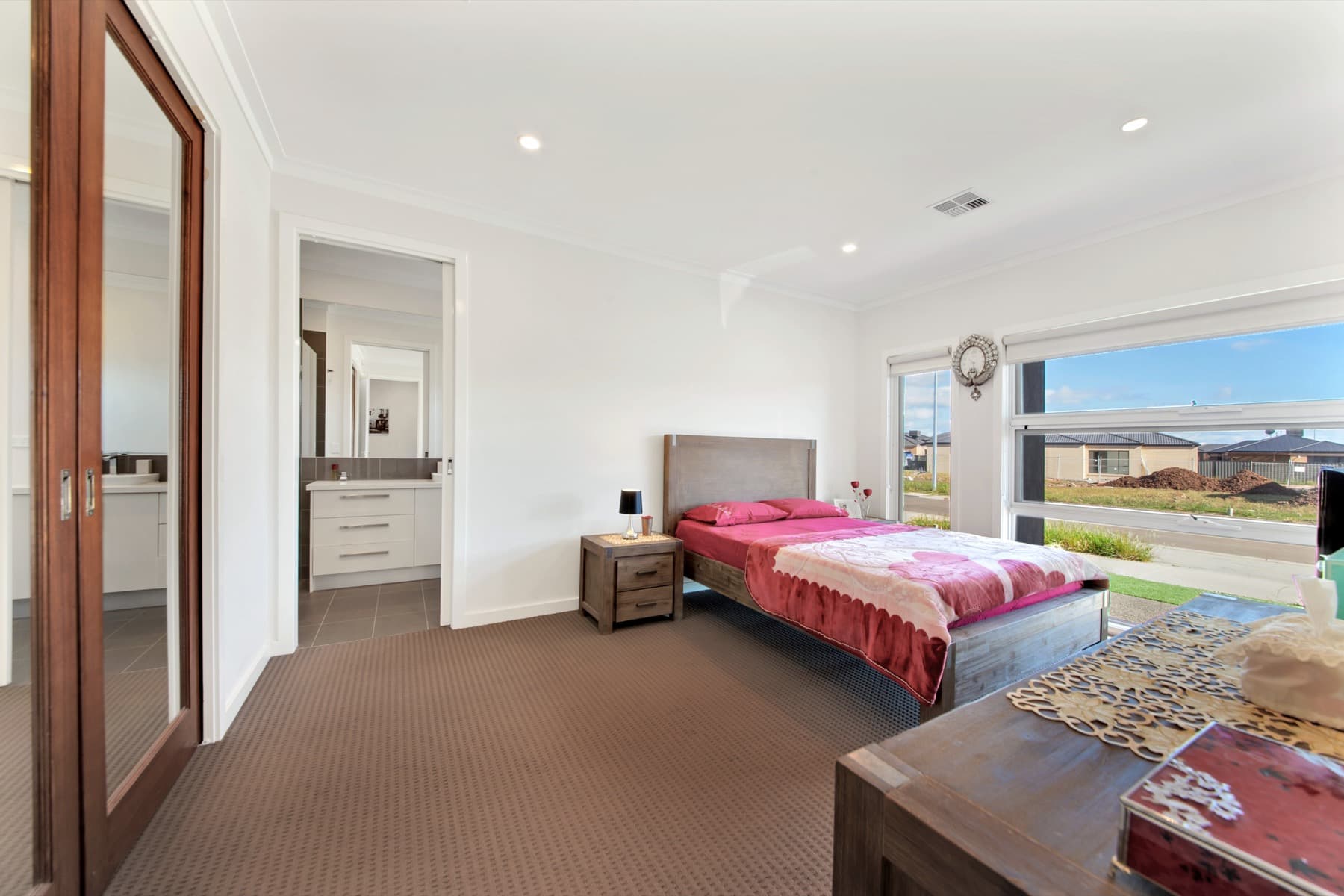 A bedroom with the ensuite beyond its door