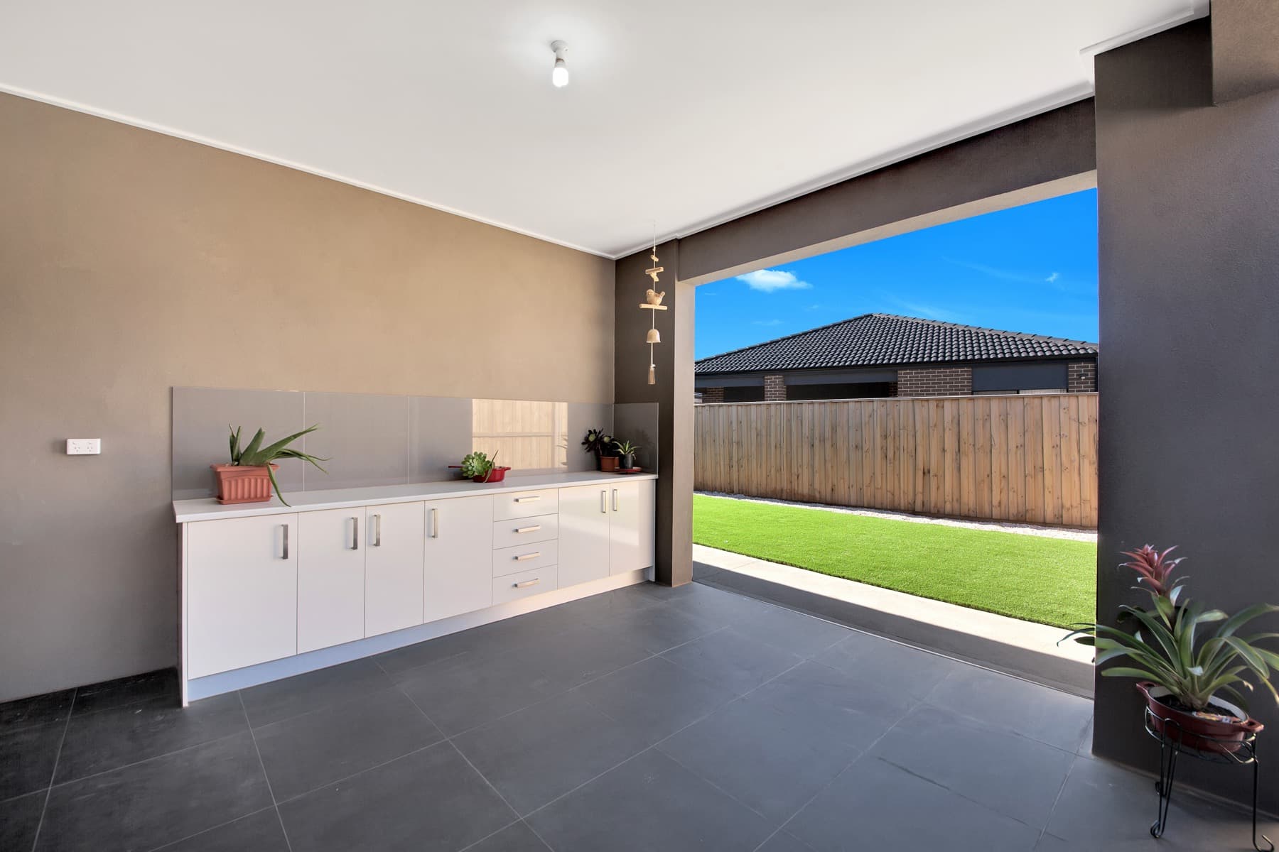 The covered alfresco with its outdoor kitchen cabinetry