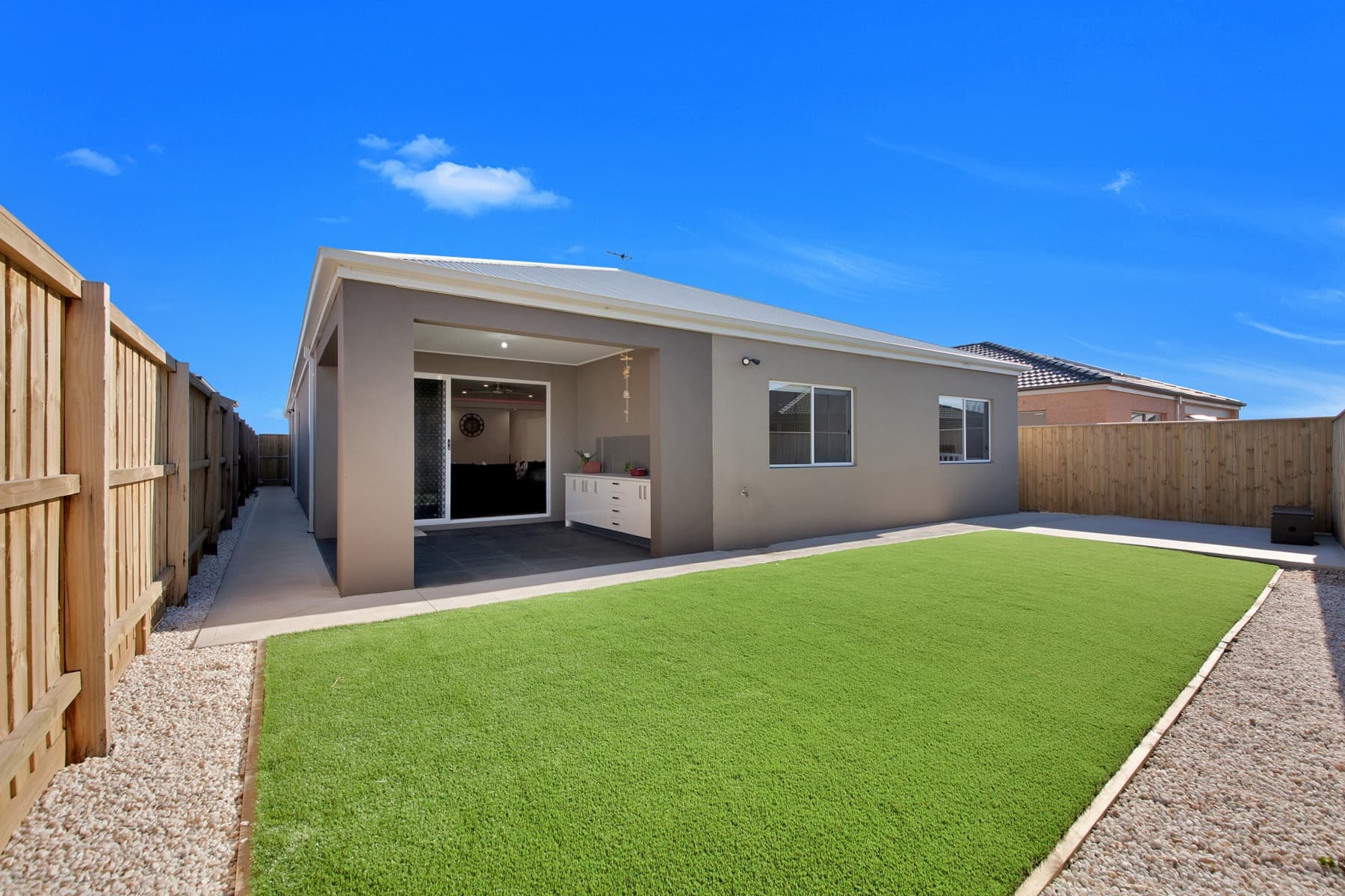 The back yard and its turfed lawn