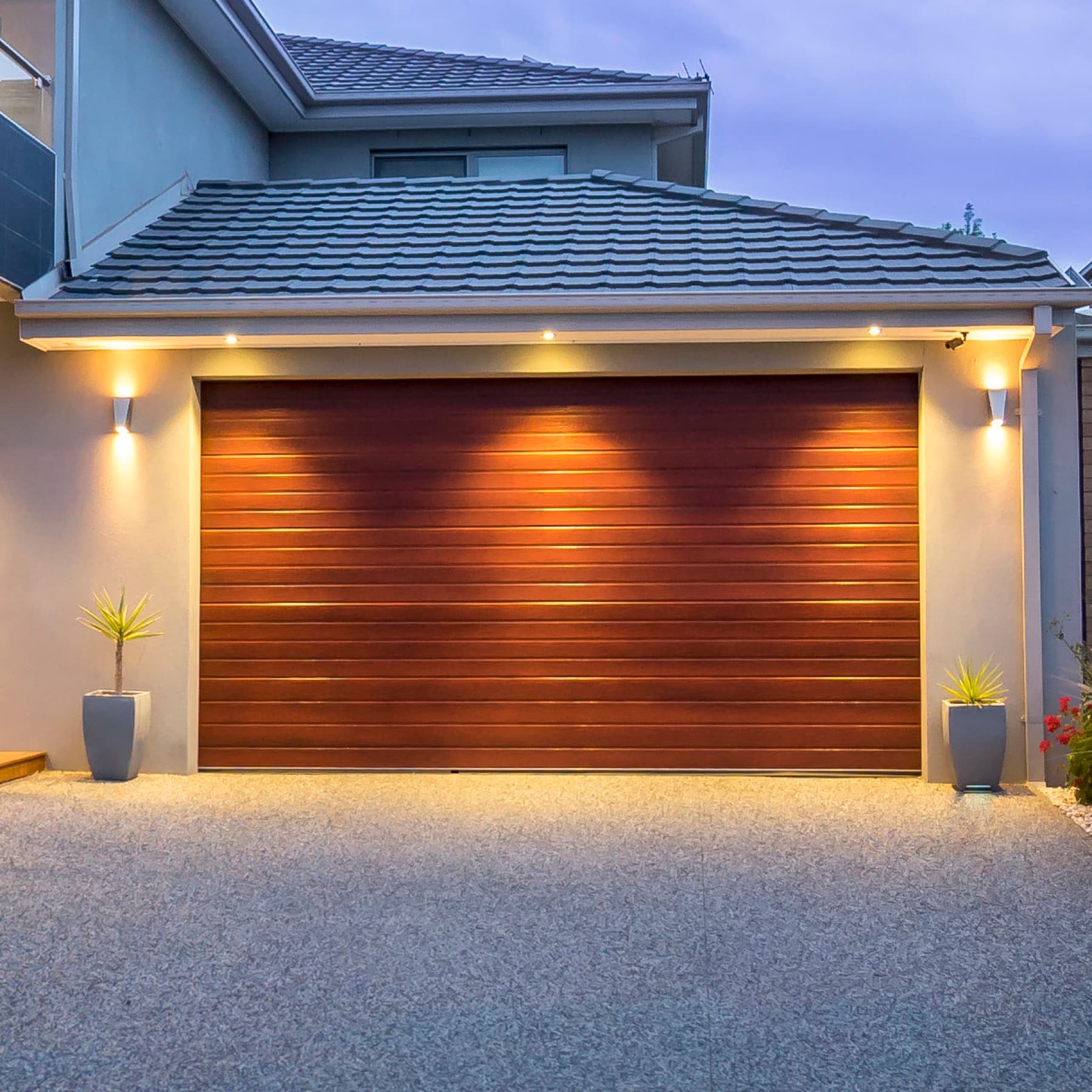The timber lined garage door under downlights