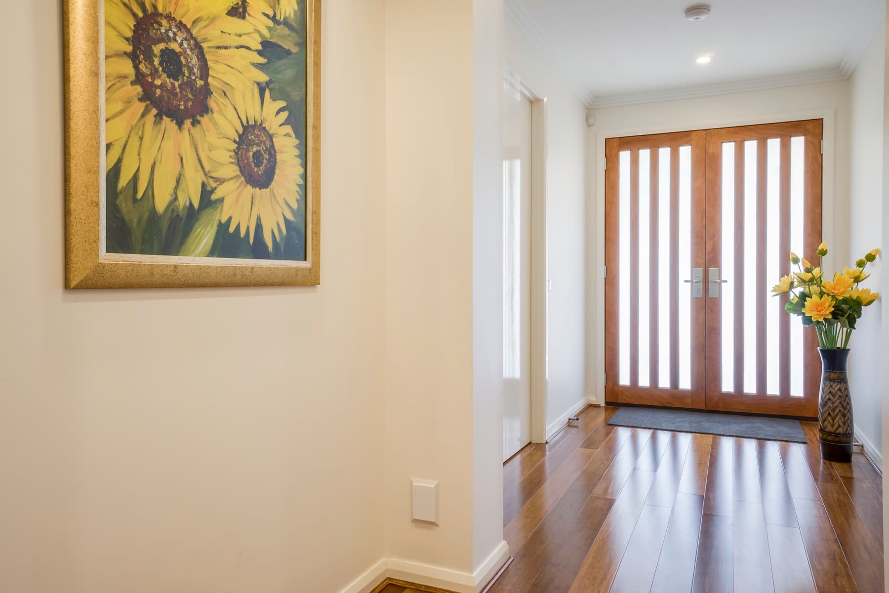 The entry, timber slat door and artwork