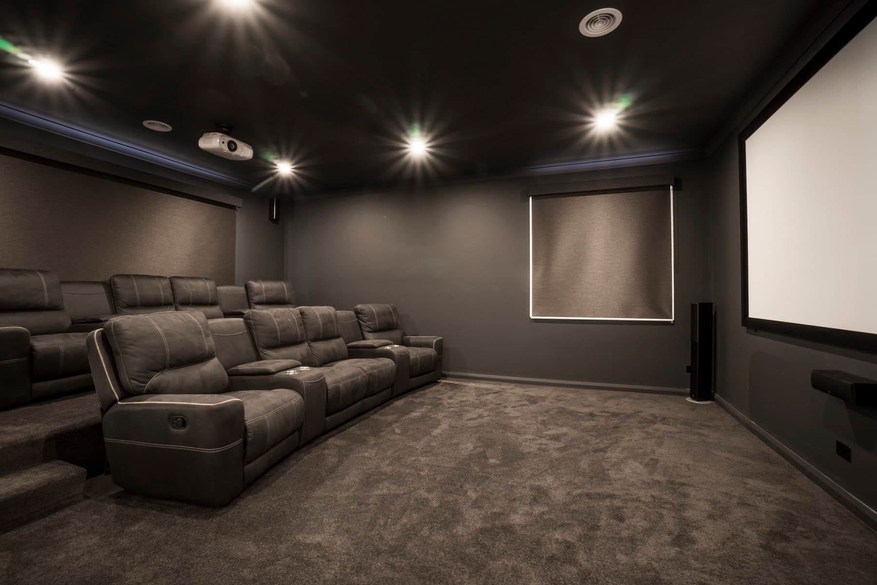 The theatre screen on its dark wall