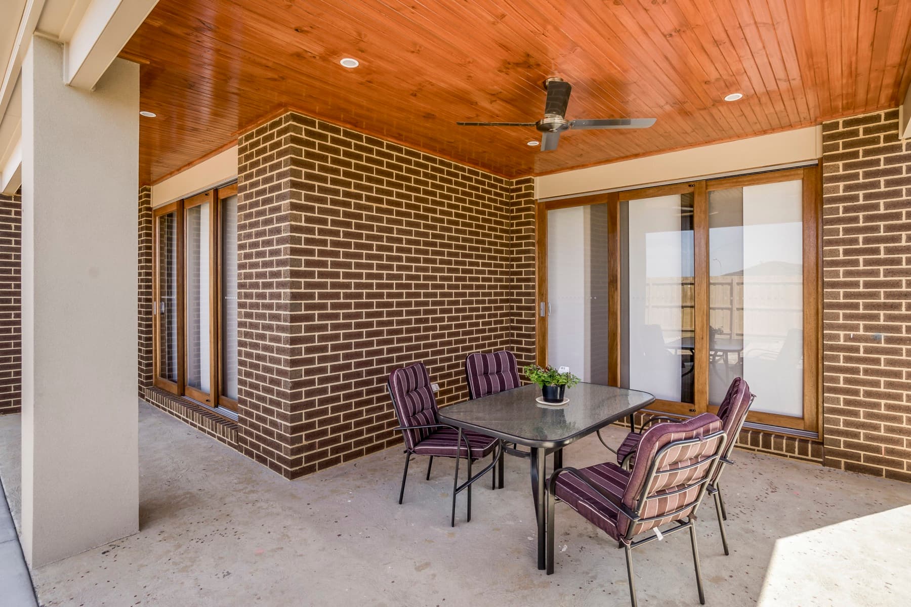 The alfresco, brick columns beneath a timber lined roof