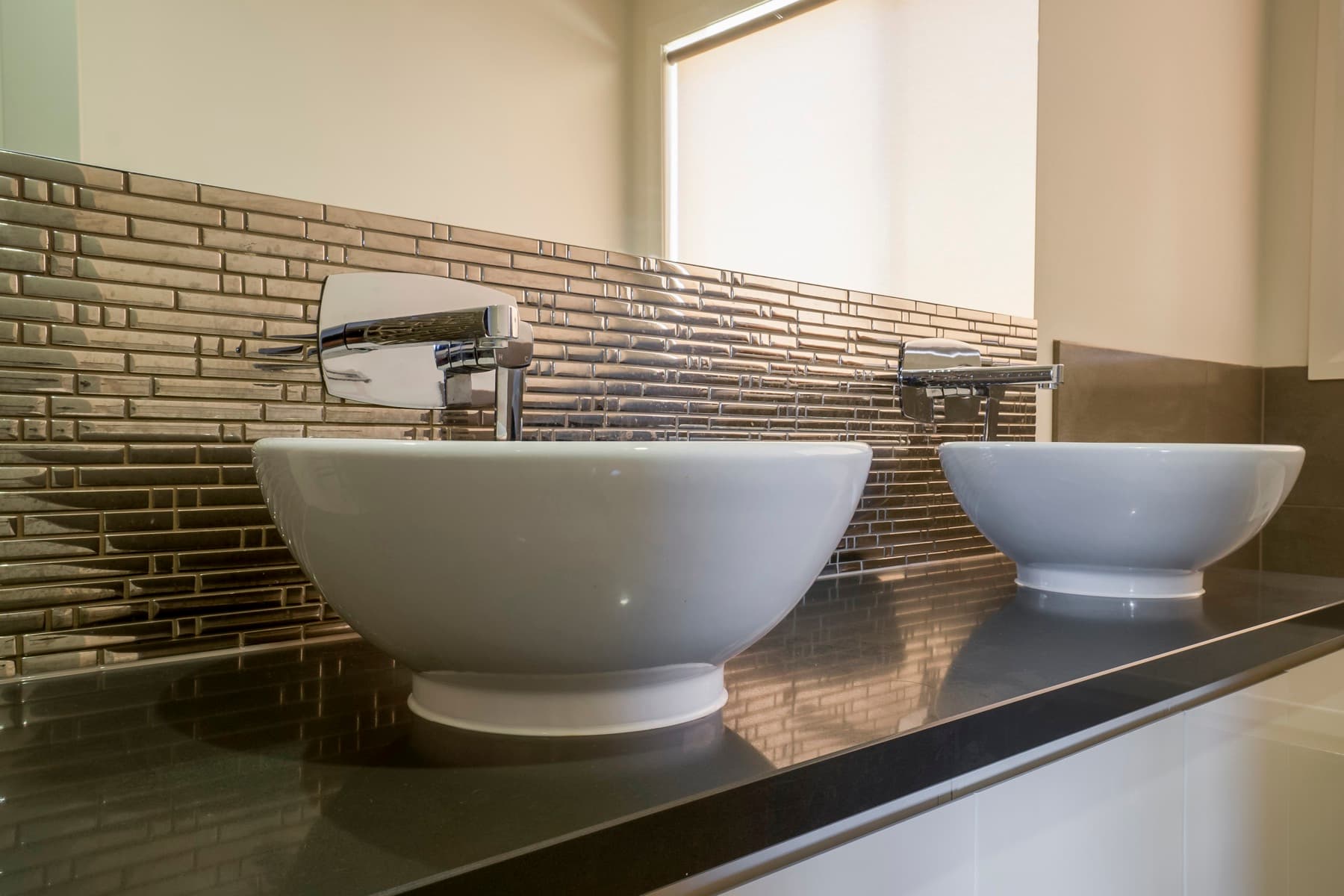 Twin vessel basins on dark stone